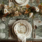 William Morris Pimpernel tablecloth in Dreamy Sage draped over a table edge