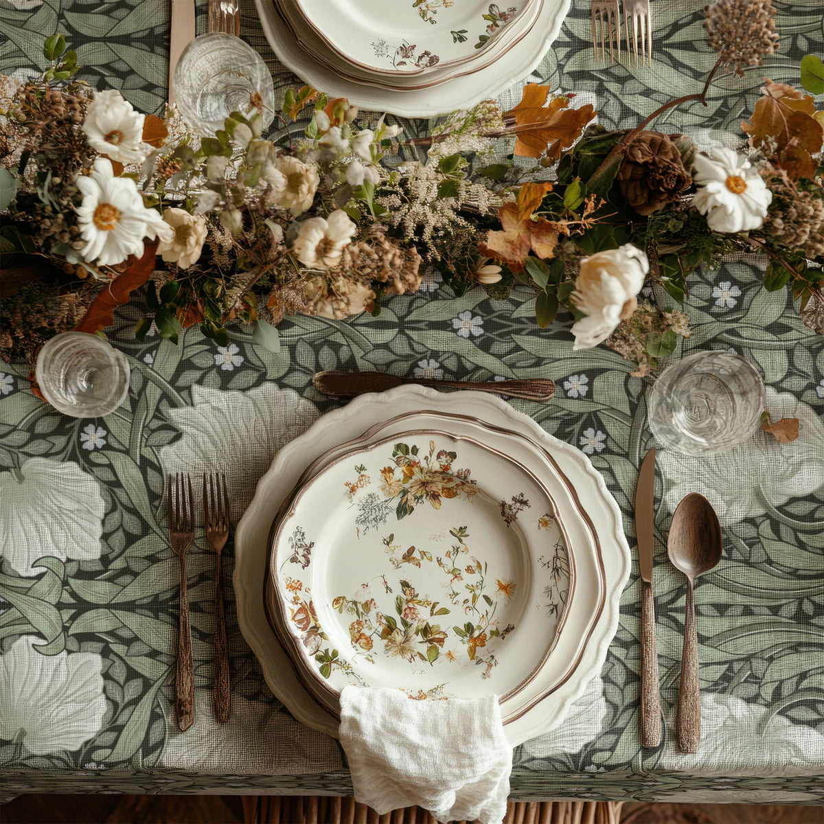 William Morris Pimpernel tablecloth in Dreamy Sage draped over a table edge