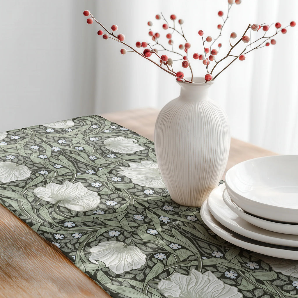 William Morris Pimpernel table runner in Dreamy Sage styled on a wooden dining table