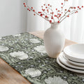 William Morris Pimpernel table runner in Dreamy Sage styled on a wooden dining table