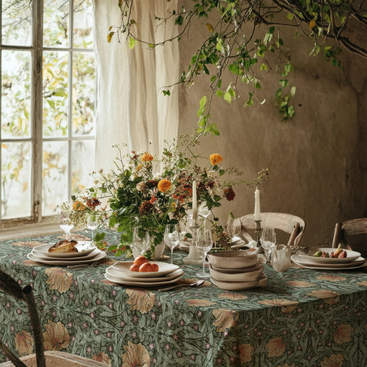 William Morris Pimpernel tablecloth in Sage and Amber on a dining table