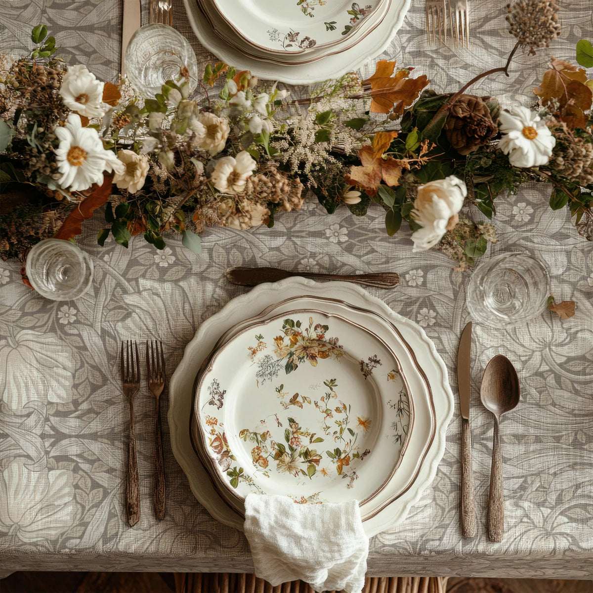 William Morris Pimpernel tablecloth in Soft Beige draped over a table edge