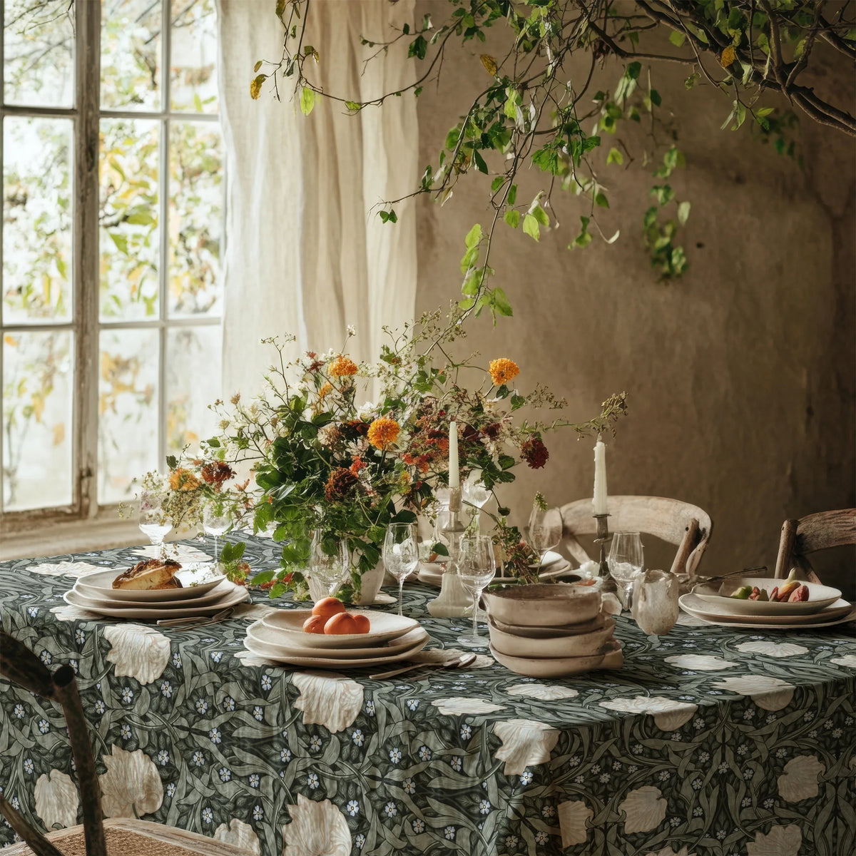 William Morris Pimpernel tablecloth in Deep Sage and Cream on a dining table