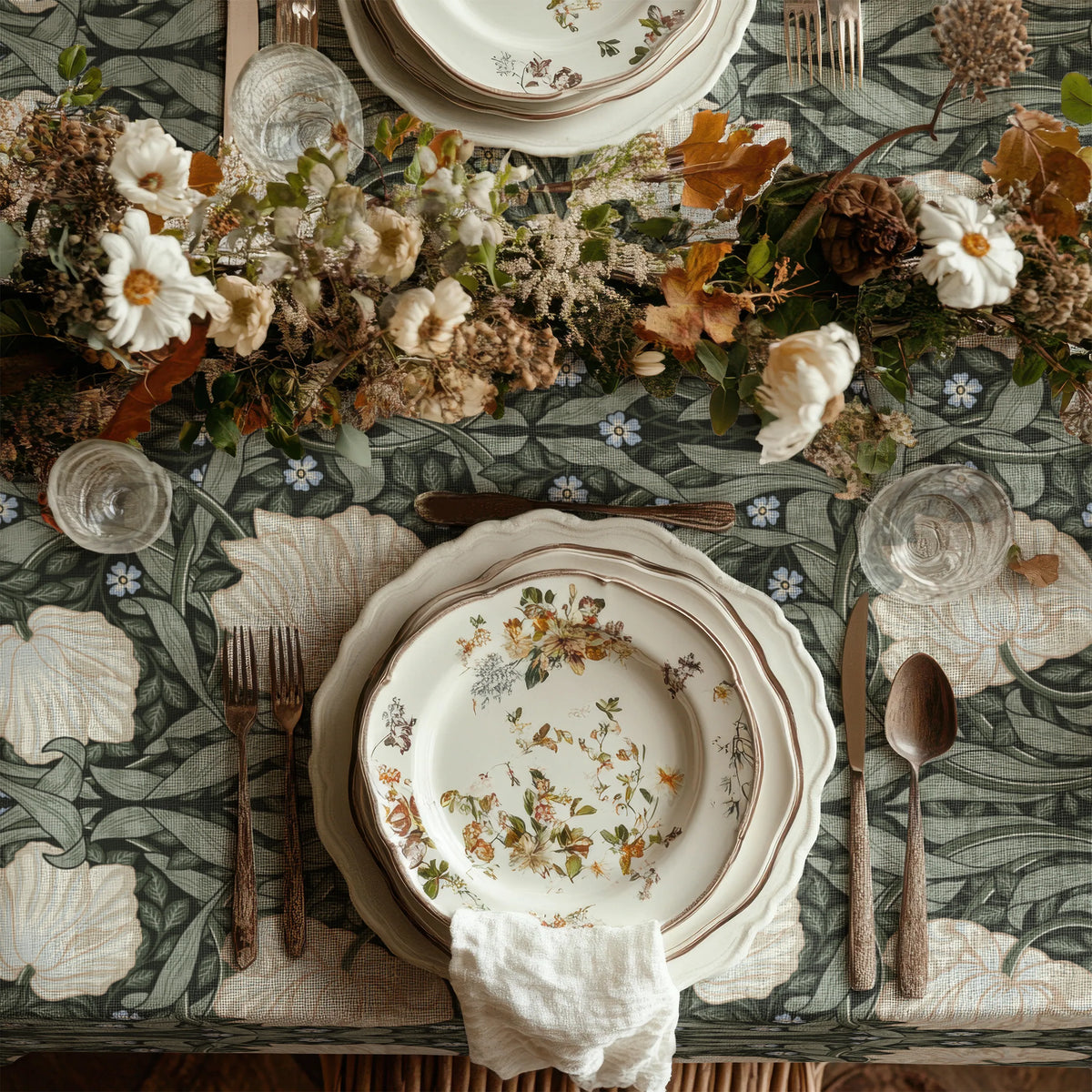William Morris Pimpernel tablecloth in Deep Sage and Cream draped over a table edge