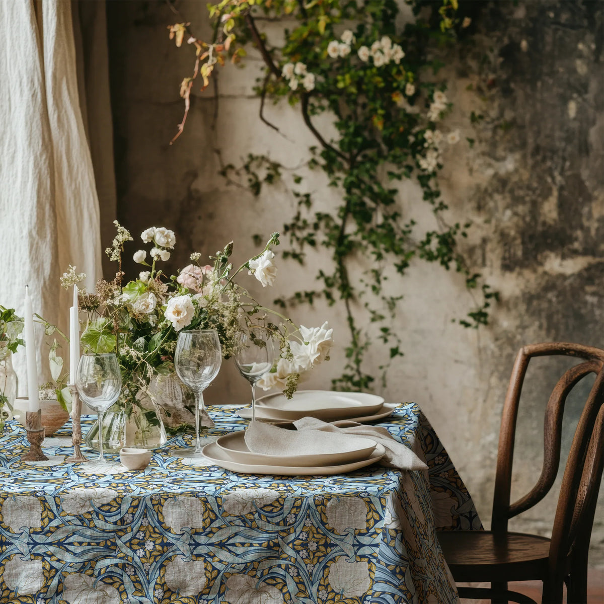 William Morris Pimpernel tablecloth in Blue and Gold with a place setting