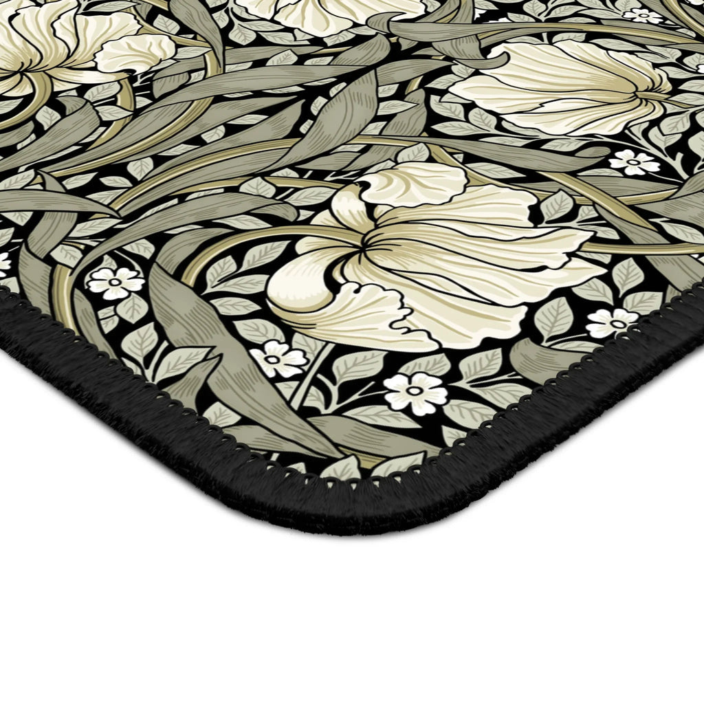 Corner close-up of the William Morris Pimpernel desk mat in Sage & Cream on Ebony, showing the printed surface and stitched edge.