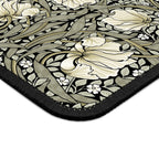 Corner close-up of the William Morris Pimpernel desk mat in Sage & Cream on Ebony, showing the printed surface and stitched edge.