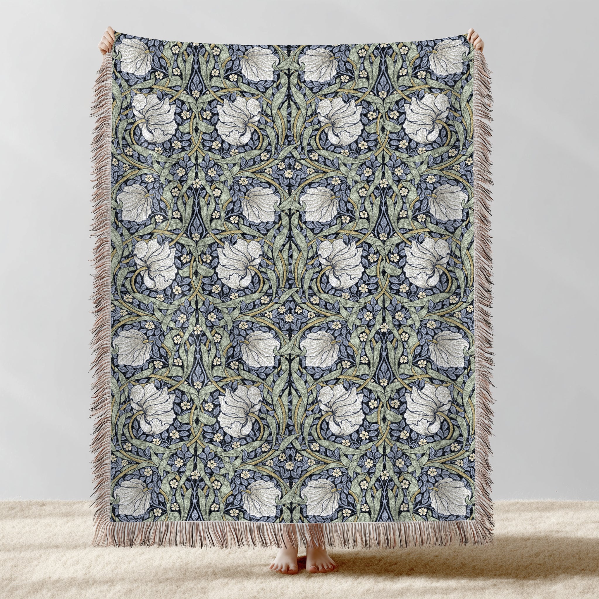 William Morris Pimpernel woven blanket displayed full length with fringe, botanical Arts and Crafts design in blue and sage green tones