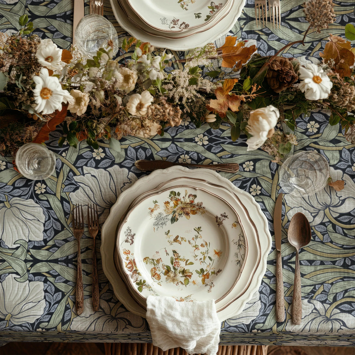 William Morris Pimpernel tablecloth in Blue and Sage draped over a table edge