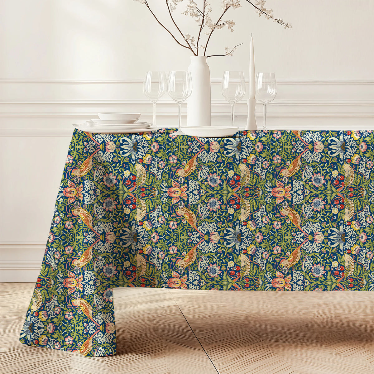 William Morris Strawberry Thief tablecloth in Country Blue (3142) draped over a dining table, showing the full drop and corner