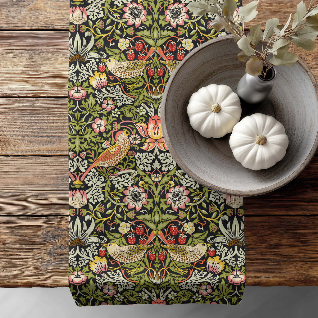 William Morris table runner Strawberry Thief - a floral and bird pattern on a wooden surface with pumpkins and a vase.