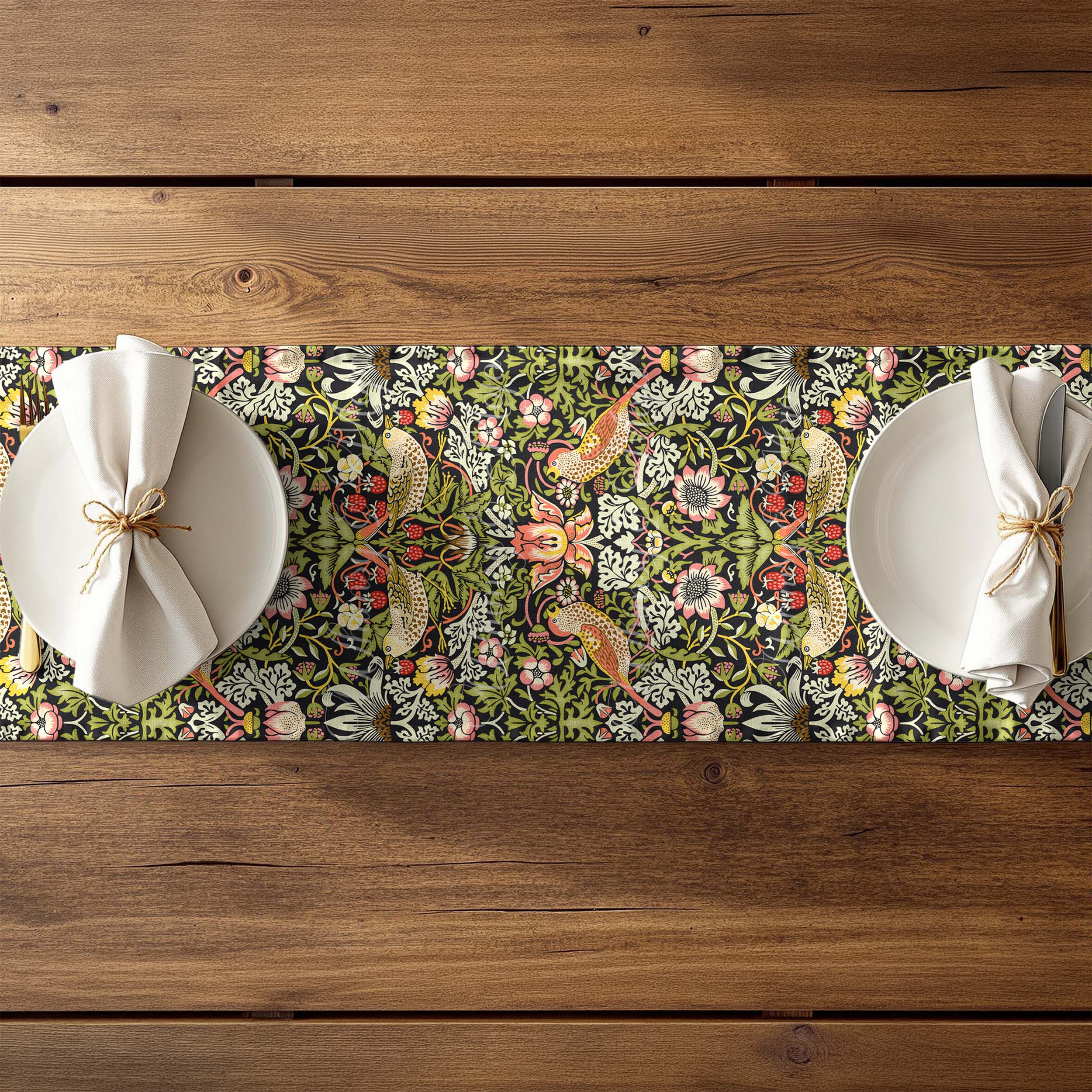 William Morris table runner featuring the Strawberry Thief design with floral and bird pattern on a wooden table.