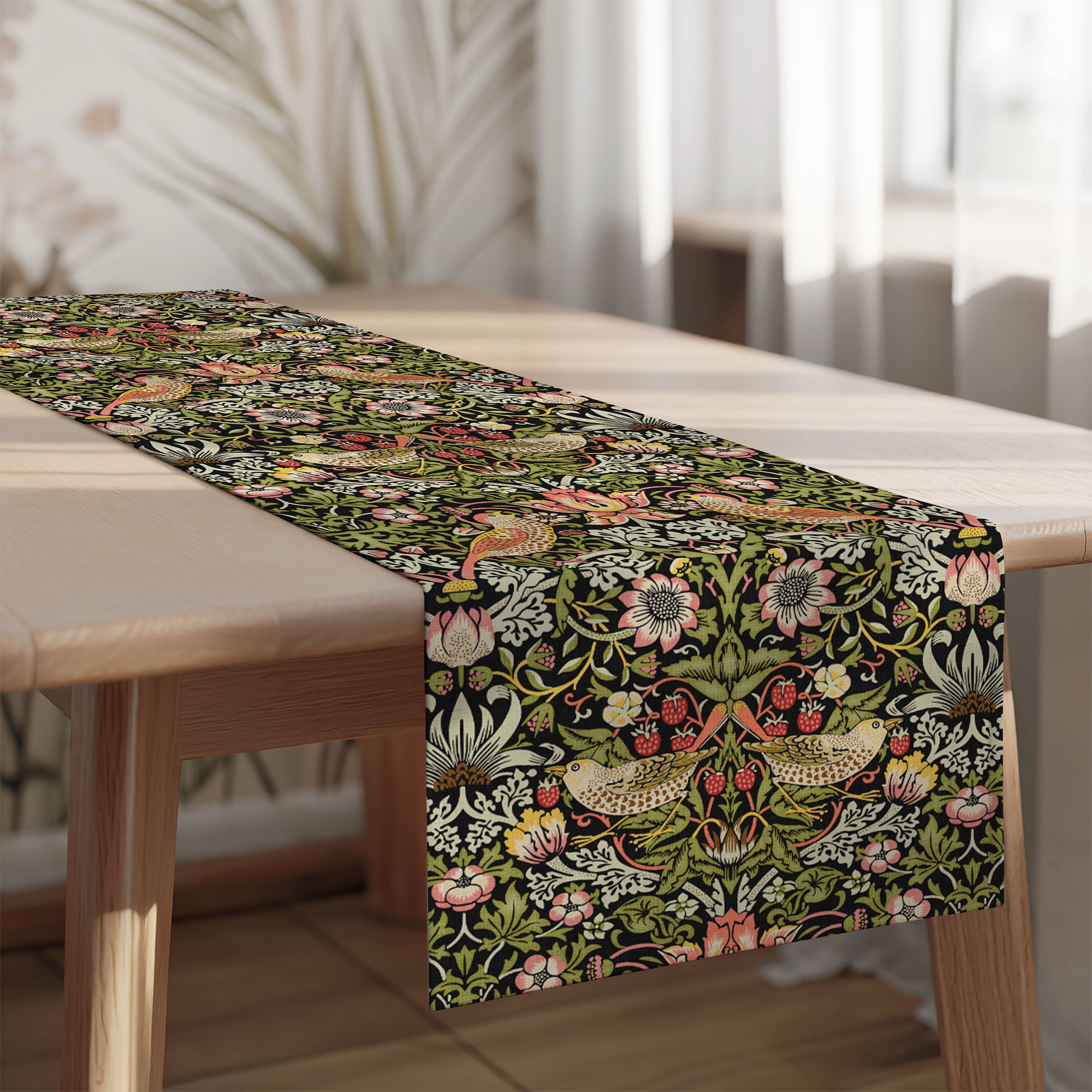 Strawberry Thief William Morris table runner on a wooden table with a blurred indoor background
