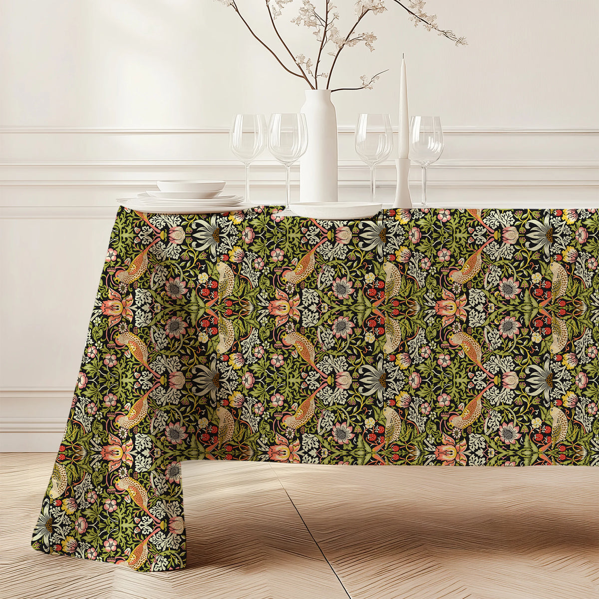 William Morris Strawberry Thief tablecloth in Classic Black (3143) draped over a dining table, showing the full drop and corner