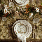 William Morris Strawberry Thief tablecloth in Golden Garden draped over a table edge