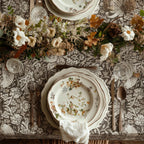 William Morris Strawberry Thief tablecloth in Country Greige draped over a table edge