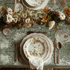 William Morris Pimpernel tablecloth in Silver Sage draped over a table edge