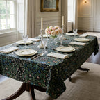 William Morris Blackthorn fabric in Classic Black sewn into a tablecloth on a dining table in a panelled English dining room.