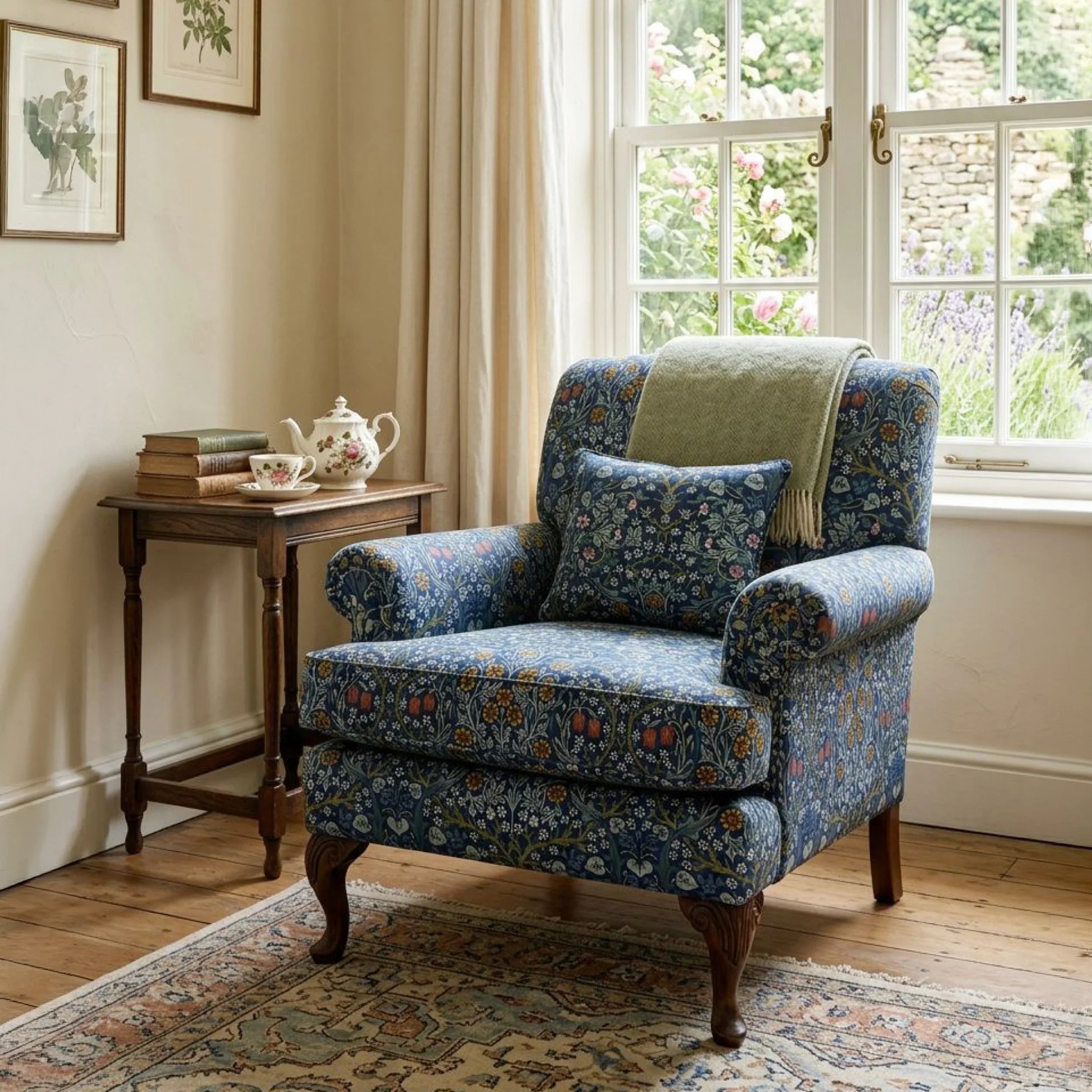 A roll-arm armchair upholstered in William Morris Blackthorn fabric in Dusky Blue Garden.