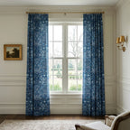 William Morris Blackthorn fabric in English Lapis made up as curtains at a tall sash window.