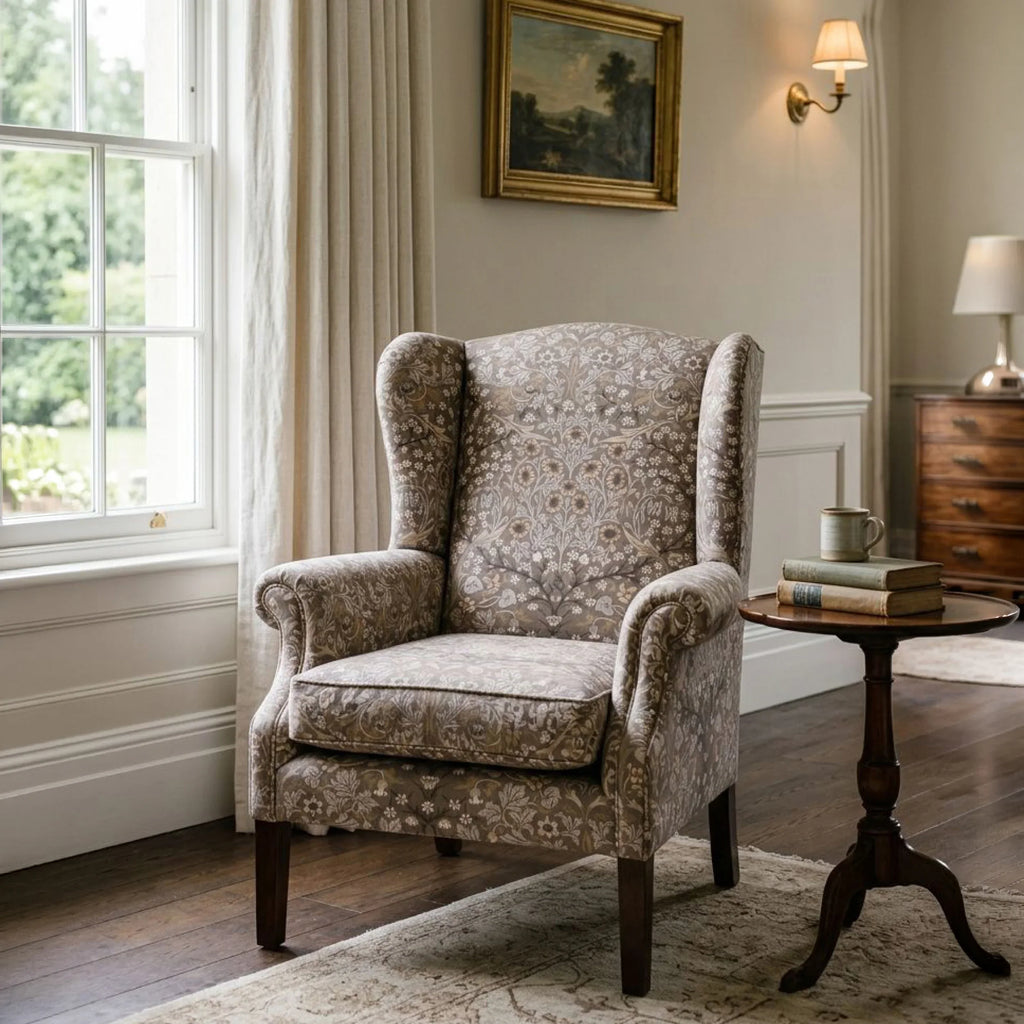 Blackthorn Heritage Taupe upholstery fabric on a wingback armchair in an elegant panelled room