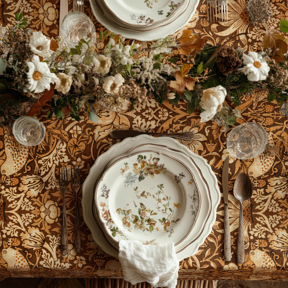 William Morris Strawberry Thief tablecloth in Pumpkin Spice draped over a table edge