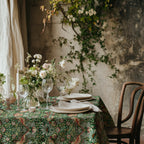 William Morris Strawberry Thief tablecloth in Forest Green with a place setting