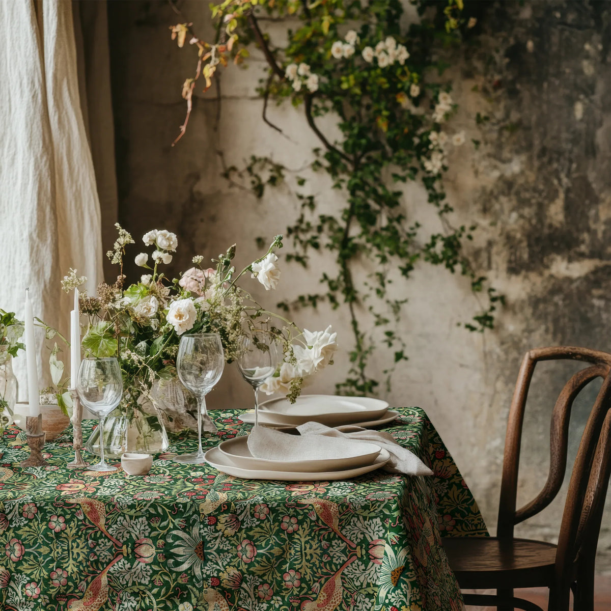 William Morris Strawberry Thief tablecloth in Forest Green with a place setting