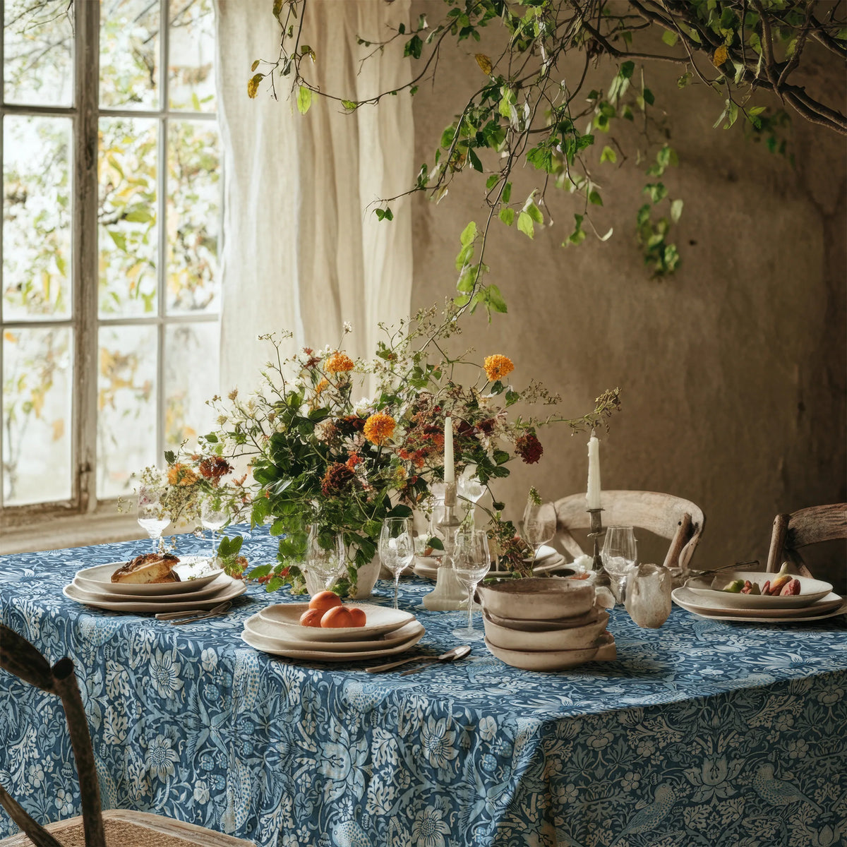 William Morris Strawberry Thief tablecloth in Chambray Blue on a dining table