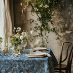 William Morris Strawberry Thief tablecloth in Chambray Blue with a place setting