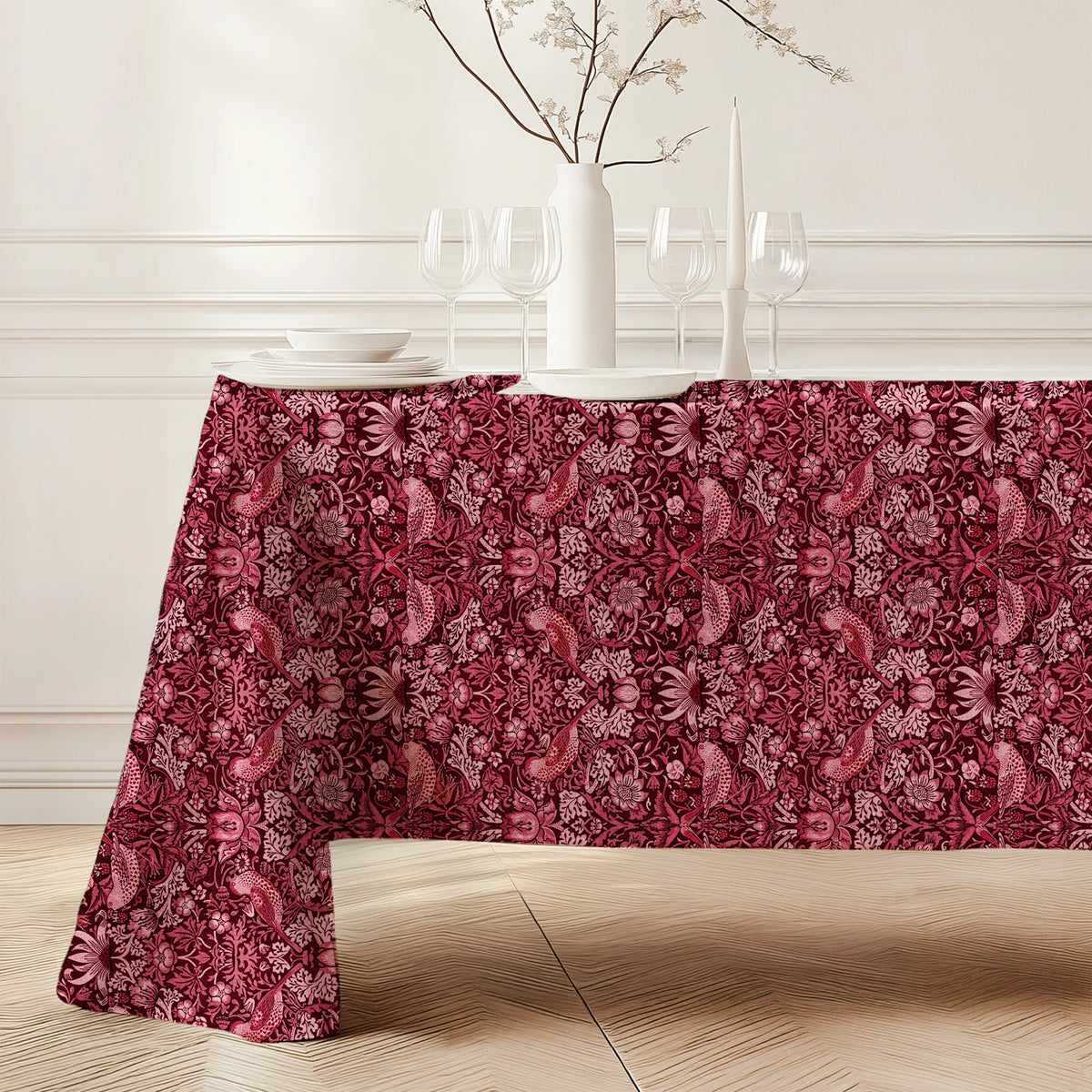 William Morris Strawberry Thief tablecloth in Mulberry Wine (4386) draped over a dining table, showing the full drop and corner