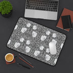 Floral patterned William Morris desk pad on a desk with laptop, notebook, and coffee cup.