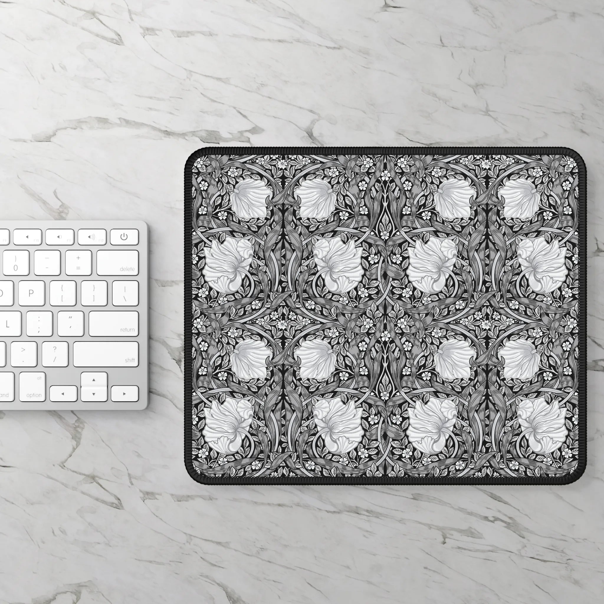 Floral patterned William Morris mouse pad on a marble surface with a keyboard.