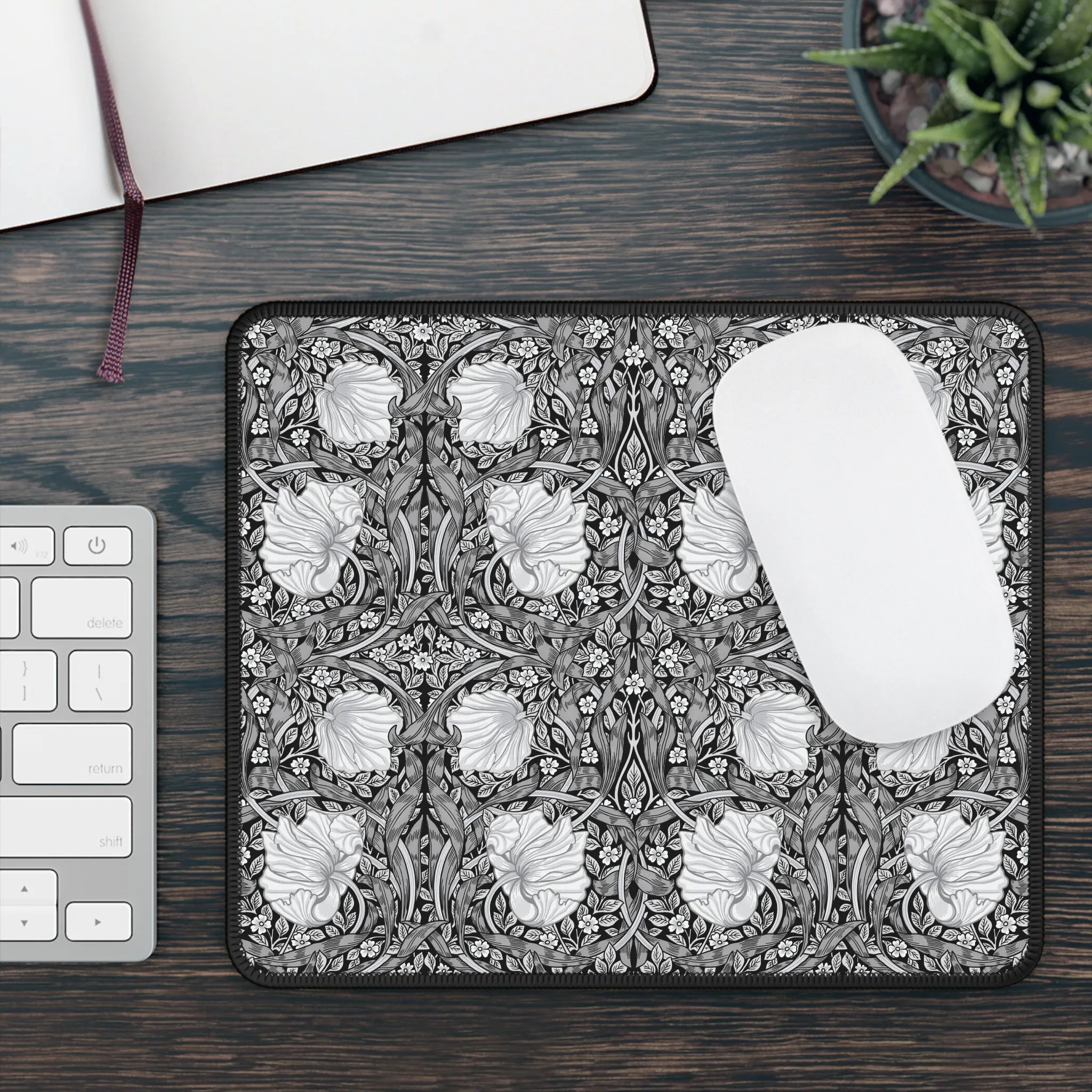 Decorative William Morris Pimpernel mouse pad with floral pattern on a wooden desk with keyboard and plant.