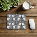 Decorative William Morris mouse pad with floral pattern on a wooden desk with a mug and plant.