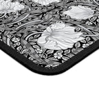 Corner close-up of the William Morris Pimpernel desk mat in Black & White, showing the printed surface and stitched edge.