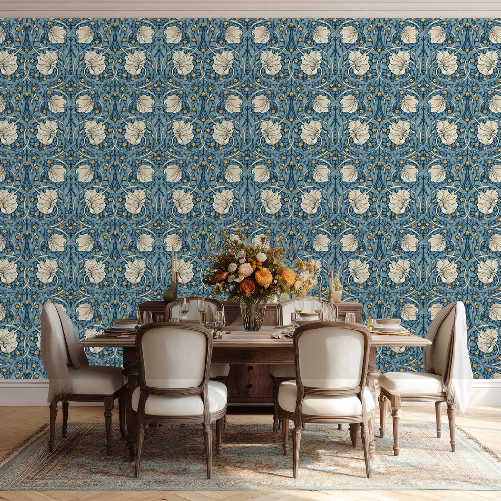 Dining room with floral William Morris Pimpernel wallpaper, an elegant wooden table and chairs.