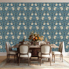 Dining room with floral William Morris Pimpernel wallpaper, an elegant wooden table and chairs.