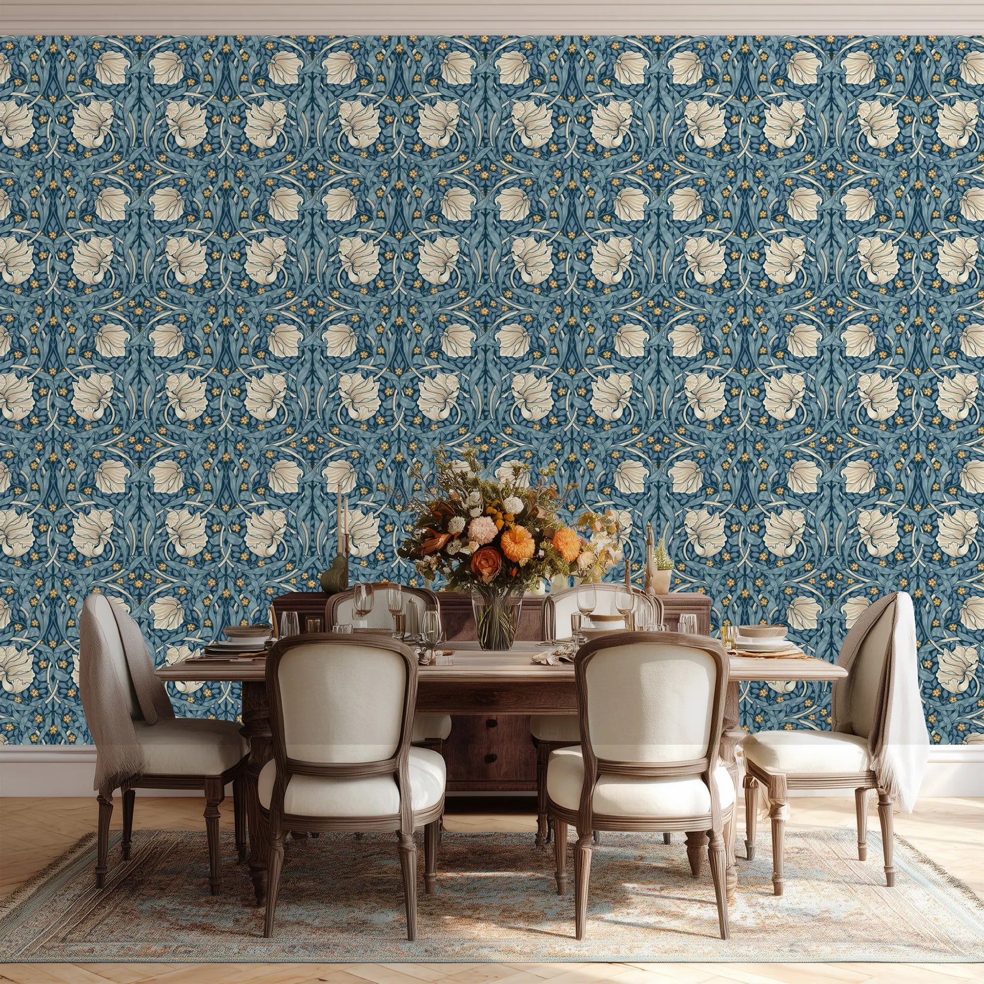 Dining room with floral William Morris Pimpernel wallpaper, an elegant wooden table and chairs.