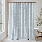 William Morris Larkspur extra long shower curtain in Powder Blue 4512: pale powder-blue larkspur on a soft white ground. Floor-length tone-on-tone cotton sateen hung from a high-mounted rod in a bright bathroom, handmade to order in 84, 96 and 108 inch lengths.