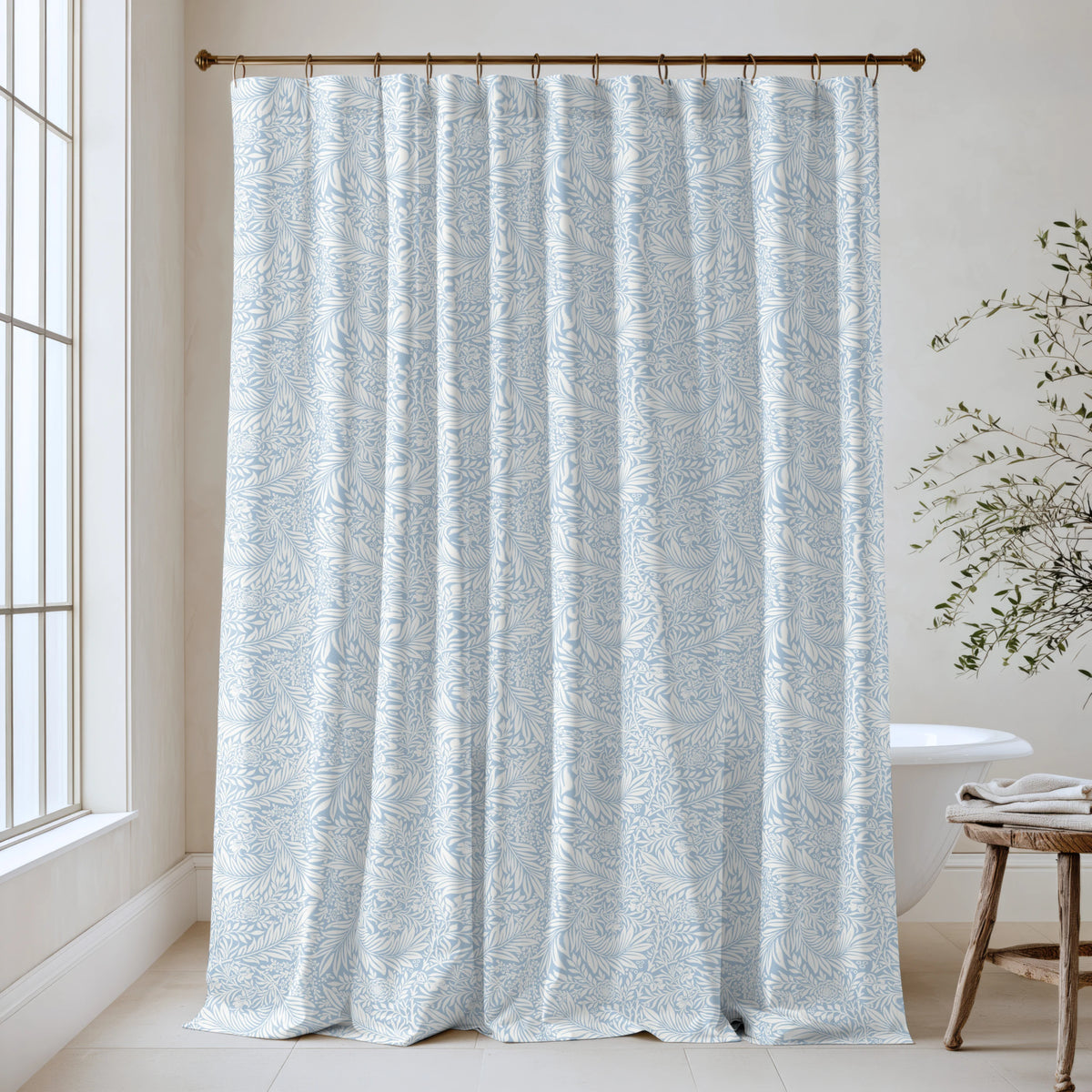 William Morris Larkspur extra long shower curtain in Powder Blue 4512: pale powder-blue larkspur on a soft white ground. Floor-length tone-on-tone cotton sateen hung from a high-mounted rod in a bright bathroom, handmade to order in 84, 96 and 108 inch lengths.