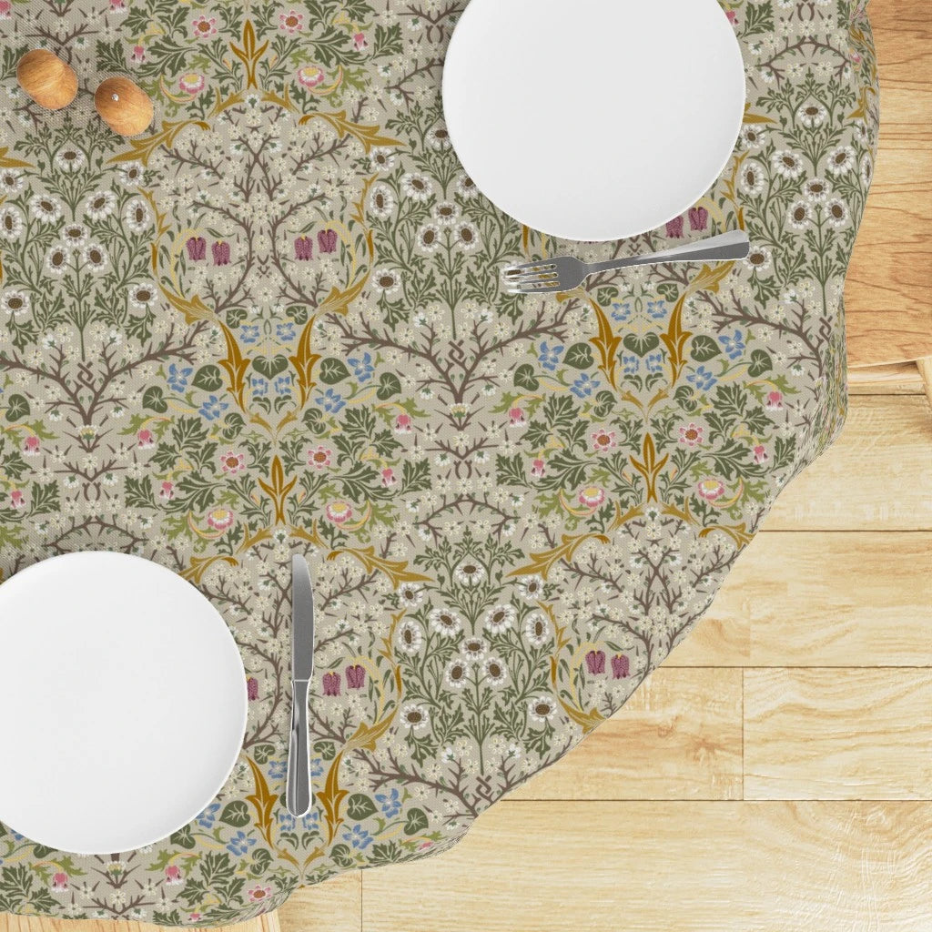 Round William Morris Blackthorn tablecloth in Parchment & Moss with white plates and cutlery