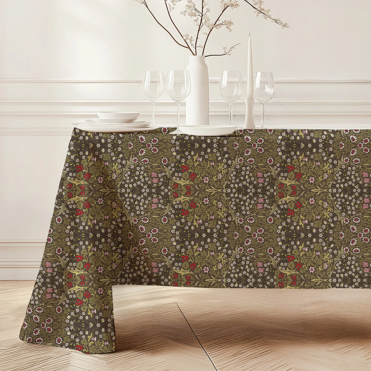 William Morris Blackthorn tablecloth in Chocolate & Olive falling to the floor on a dining table with a white vase and candles