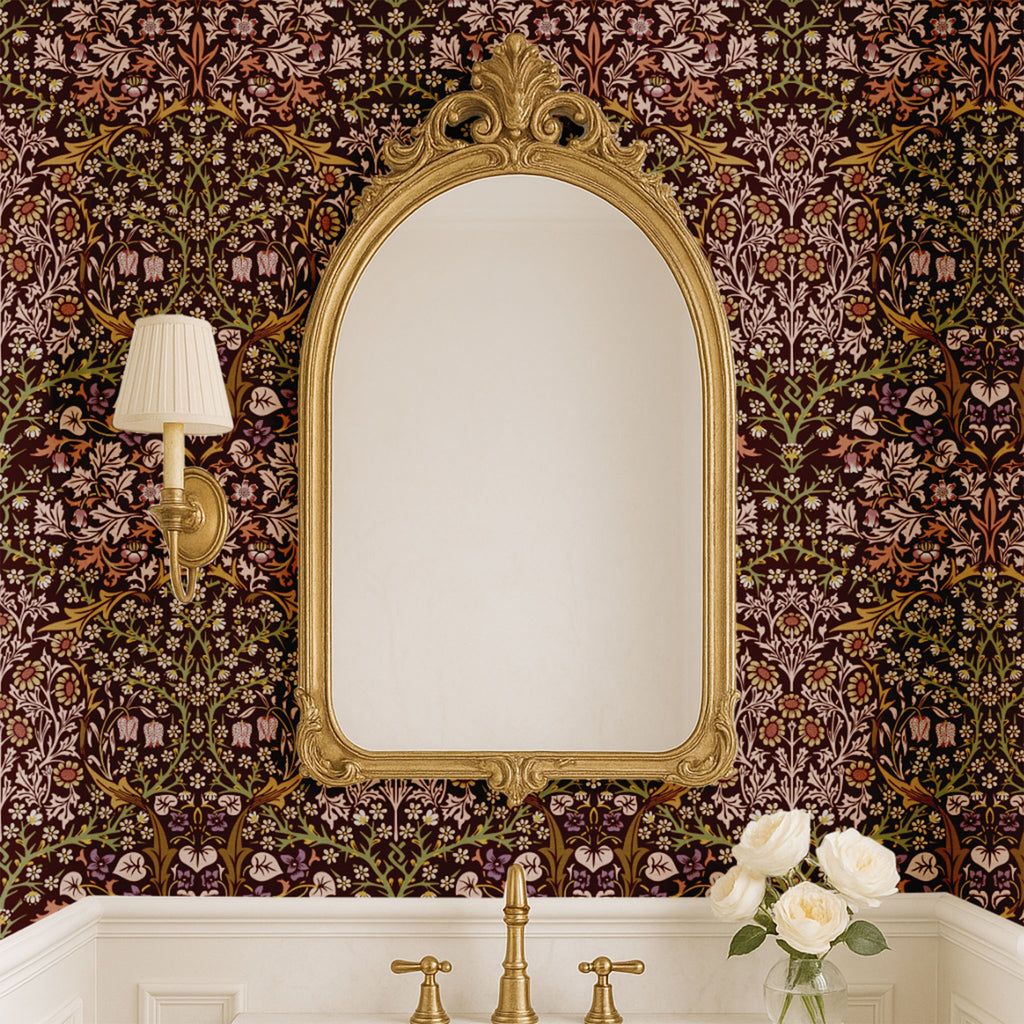 Bathroom with ornate mirror set against William Morris Blackthorn wallpaper in maroon, showcasing elegant Arts and Crafts botanical decor.