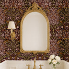 Bathroom with ornate mirror set against William Morris Blackthorn wallpaper in maroon, showcasing elegant Arts and Crafts botanical decor.