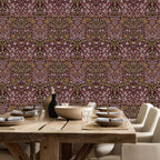 William Morris Blackthorn wallpaper in maroon styled in a dining room with rustic wood table, showcasing a classic Arts and Crafts botanical pattern for cottagecore decor.