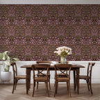 William Morris Blackthorn wallpaper in maroon styled in a dining space with neutral furnishings, emphasizing heritage revival and cottagecore interior styling.