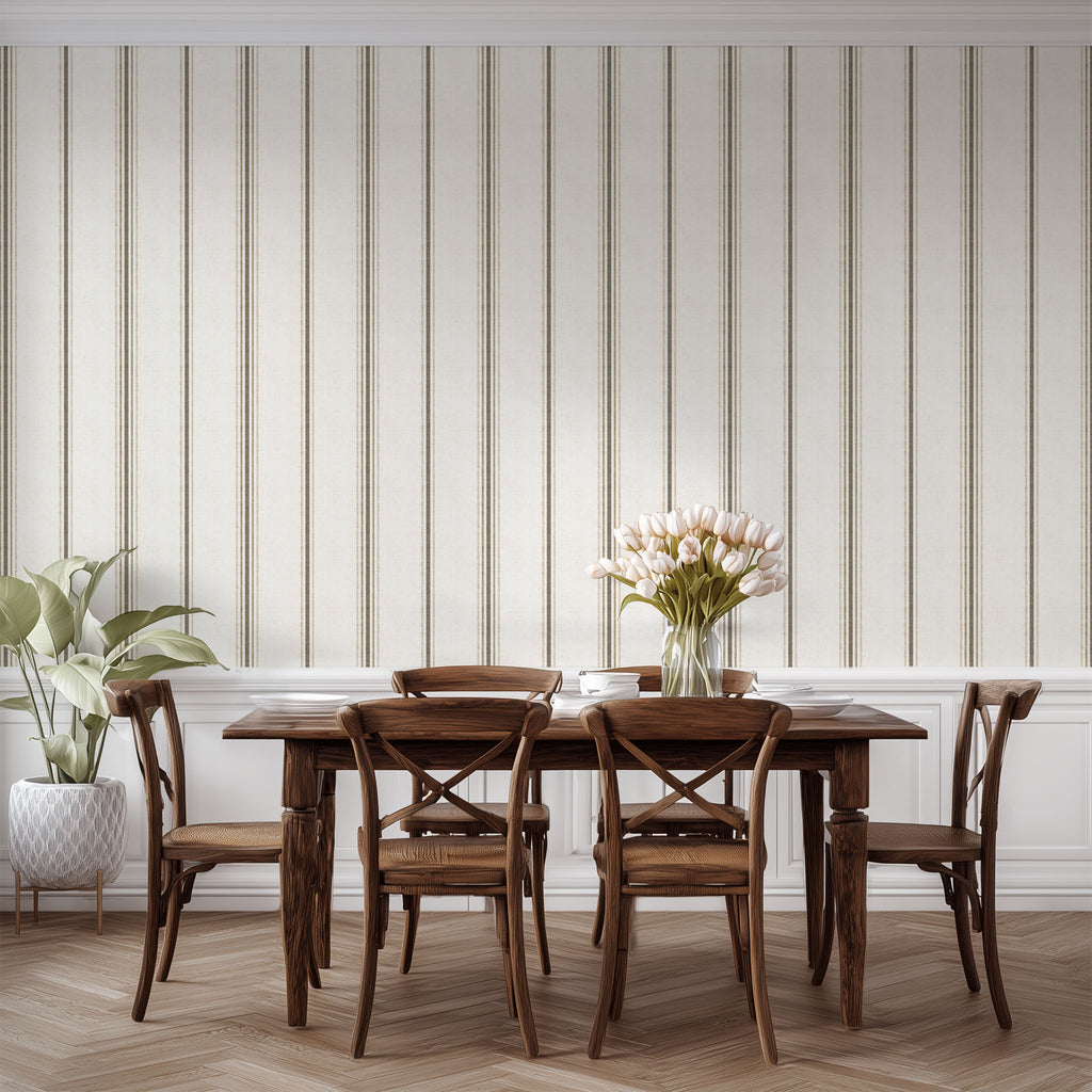 Neutral stripe wallpaper in linen and tobacco styled in a dining space, emphasizing cottagecore, farmhouse, and French country decor.