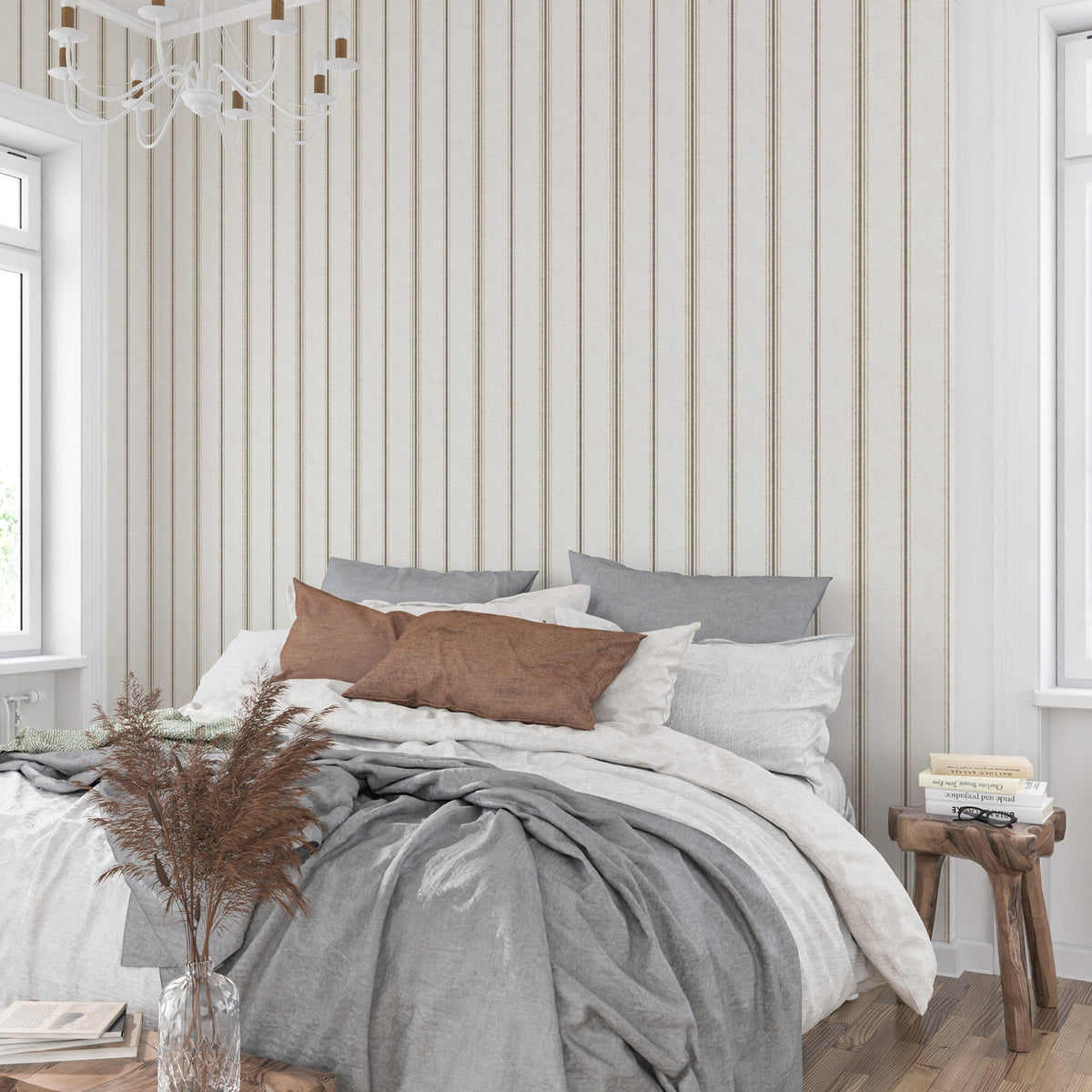 Neutral stripe wallpaper in linen and tobacco tones behind a bed, creating a calm French country bedroom with cottagecore and heritage-inspired decor.