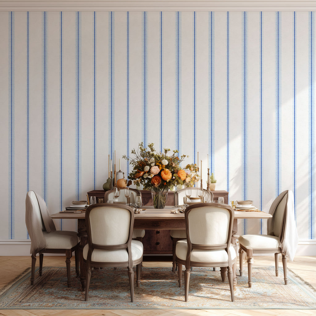 French country stripe wallpaper in Chalk and French Blue tones styled in a dining room, featuring a timeless vertical stripe pattern for neutral interiors.
